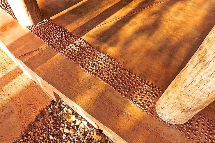 Pebble floor border, welcome center, Akagera National Park, Rwanda:enclos*ure