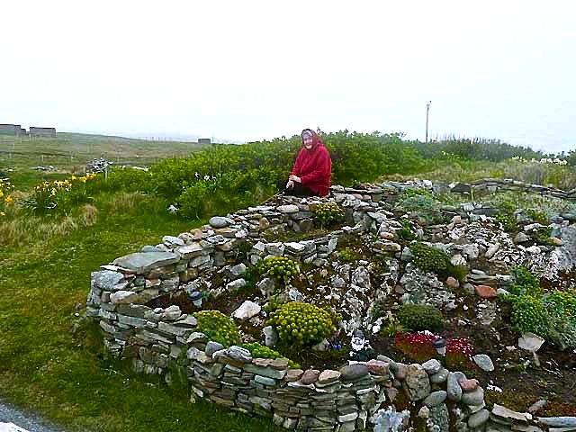Garden and gardener at Gravens, Shetland Islands, by Oliver Dixon.  He wrote: "Despite the unpromising climate, there are some very keen gardeners on Shetland, with some fine examples of rock gardens."